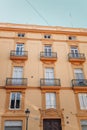 Windows with shutters and small balconies outside on the building facade downtown Barcelona, Spain Royalty Free Stock Photo