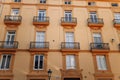 Windows with shutters and small balconies outside on the building facade downtown Barcelona, Spain Royalty Free Stock Photo