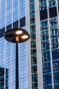 Windows of business office building with street lamp at front, Corporate buildings in city Royalty Free Stock Photo