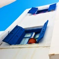 Windows with trditional blue shutters in Mykonos