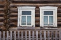 Windows of a typical old russian wooden house and a fence. Village Kimzha, Arkhangelsk region. Russia Royalty Free Stock Photo