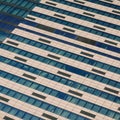 Windows of under construction high-rise building. Front view of modern glass and concrete exterior of high rise building Royalty Free Stock Photo