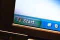 Windows XP start menu bar, windows logo on an old low resolution lcd display, closeup, pixels visible. Old windows logo