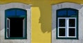 Windows and yellow colored facade building in Lisbon, Portugal Royalty Free Stock Photo