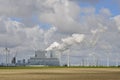 Wind Powered Generators line a large Fossil Fuel Power Plant Royalty Free Stock Photo