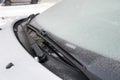 Windscreen wipers cleaning a windshield of a car from  snow Royalty Free Stock Photo