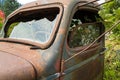 Windshield and driver side window with bullet holes on a rusty antique truck Royalty Free Stock Photo