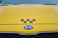 The windshield and hood of a yellow Kia Rio taxi car frozen after the first autumn frost - Moscow, Russia, November 19, 2020 Royalty Free Stock Photo