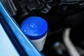 Windshield washer fluid reservoir cap in engine room Royalty Free Stock Photo