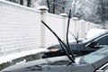 Windshield wiper raised up and icy car windshield. Leave Windshield Wipers Up in the Ice and Snow. Royalty Free Stock Photo