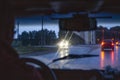 Windshield wipers from inside of car, season rain, front and background blurred with bokeh effect