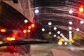 Windshield wipers from inside of car, season rain, front and background blurred with bokeh effect