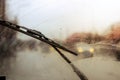 Windshield wipers from inside of car, season rain, front and background blurred with bokeh effect