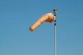 Windsock indicating wind direction and relative speed on blue sky background Royalty Free Stock Photo