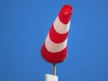 Windsock indicator of wind on runway airport. Wind cone indicating wind direction and force. Horizontally flying windsock Royalty Free Stock Photo