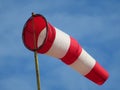 Windsock indicator of wind on runway airport. Wind cone indicating wind direction and force. Horizontally flying windsock Royalty Free Stock Photo