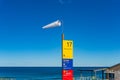 Windsock and information board. High wind on the beach