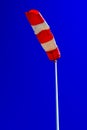 windsock in operation with strong blue sky background. Royalty Free Stock Photo