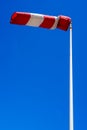 windsock in operation with strong blue sky background. Royalty Free Stock Photo