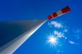 windsock in operation with strong blue sky background with sun Royalty Free Stock Photo