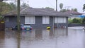 WINDSOR, AUSTRALIA - MAR, 23, 2021: front view of a car and house at windsor under floodwater
