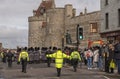 A uniformed ceremonial warden with arms outstretched on crowd control. Windsor, UK