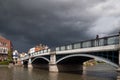 WINDSOR, BERKSHIRE/UK - APRIL 27 : Woman looking over Eton bridge as a storm approaches in Windsor on April