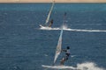 The windsurfer on the board under sail moves at a speed along th