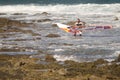 Windsurfer carrying his windsurf board.