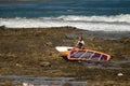 Windsurfer carrying his windsurf board. Royalty Free Stock Photo
