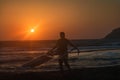 Windsurfer with his surf getting out of water on Prasonisi beach, sunset Rhodes, Greece Royalty Free Stock Photo