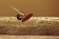 Windsurfer jumping in a sunset sky Royalty Free Stock Photo