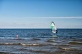 Windsurfer or man sportsman surfs and sails on board Royalty Free Stock Photo