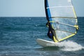 Windsurfer moving on the waves Royalty Free Stock Photo