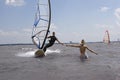 Windsurfer reaching for girlfriend