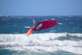 Windsurfer during a jump called backloop over the waves of the Atlantic Ocean, Tenerife, Spain