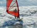 Windsurfer red sail white surf
