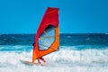 Windsurfer riding the waves on the blue ocean Royalty Free Stock Photo