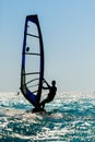 Windsurfer silhouette against sun Royalty Free Stock Photo