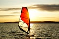 Windsurfer silhouette against a sunset background Royalty Free Stock Photo