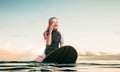 Windsurfer sitting on board and talks by phone