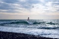 Windsurfer surfing through wavy sea at flying aircraft background Royalty Free Stock Photo