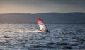 Windsurfer Surfing The Wind On Waves at Sunset Royalty Free Stock Photo