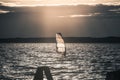 Windsurfer Surfing The Wind On Waves at Sunset Royalty Free Stock Photo