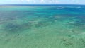 Windsurfers and kiters in tropical ocean at paradise Mauritius. Aerial view.