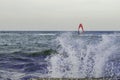 Windsurfers riding waves on a bright cold day Royalty Free Stock Photo