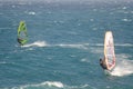 Windsurfers sailing in the sea.