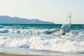 Windsurfers in the sea on Crete on sunset. Windsurfing in Heraklion. Greece