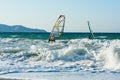 Windsurfers in the sea on Crete on sunset. Windsurfing in Heraklion