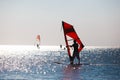 Windsurfers in the sea during sunset, active lifestyle